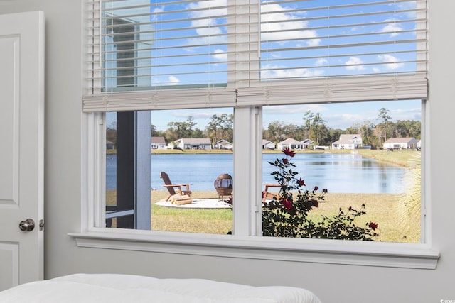 bedroom featuring multiple windows and a water view