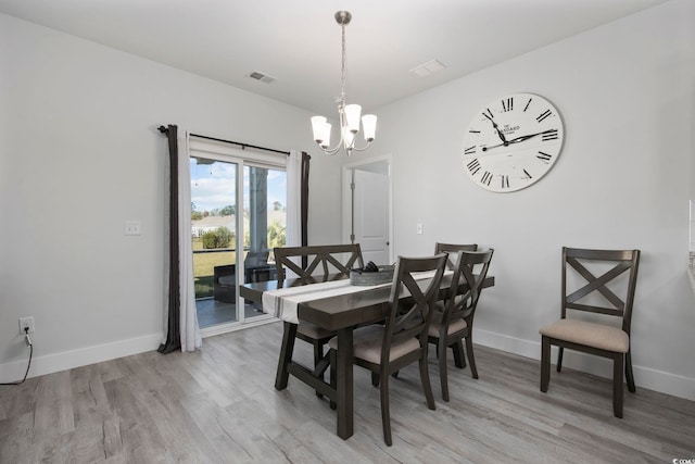 dining room featuring a chandelier and light hardwood / wood-style flooring