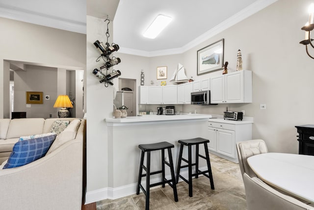 4491 Horseshoe Bnd, Murrells Inlet, SC 29576 - kitchen featuring stainless steel microwave, open floor plan, ornamental molding, a breakfast bar, and a peninsula