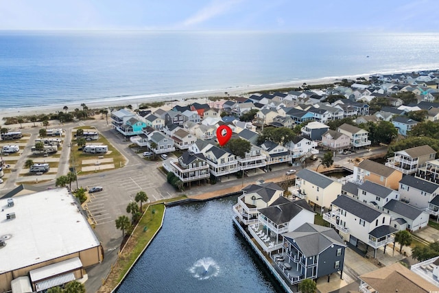 bird's eye view featuring a view of the beach and a water view