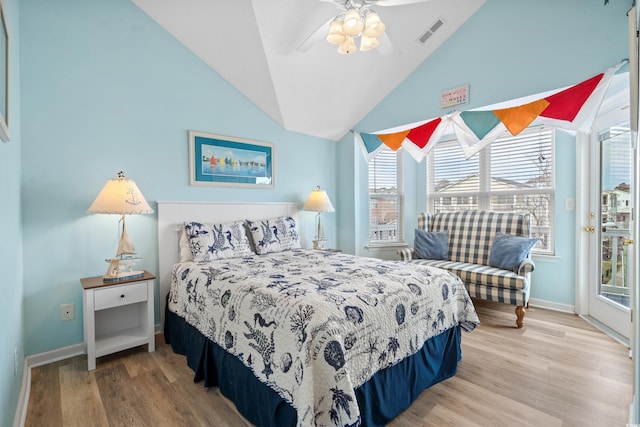 bedroom with multiple windows, hardwood / wood-style floors, access to outside, and ceiling fan