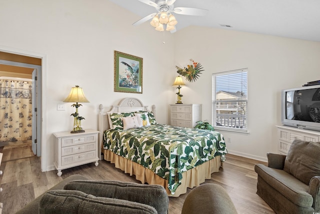 bedroom featuring ceiling fan, lofted ceiling, and hardwood / wood-style flooring