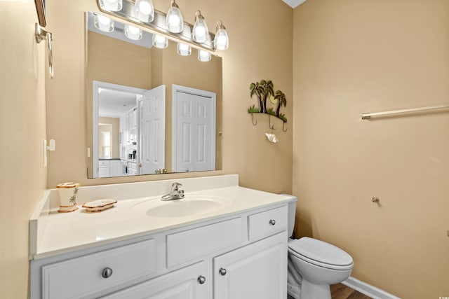 bathroom featuring hardwood / wood-style flooring, vanity, and toilet