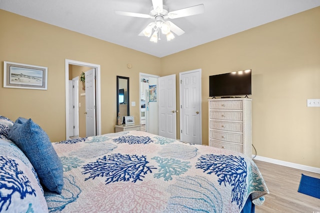 bedroom featuring light hardwood / wood-style floors, ensuite bath, and ceiling fan