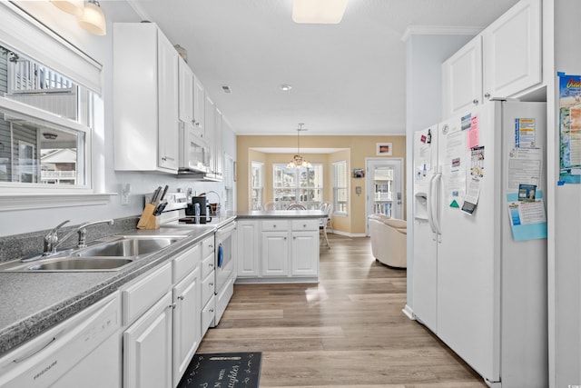 kitchen with white cabinets, white appliances, light hardwood / wood-style flooring, and hanging light fixtures