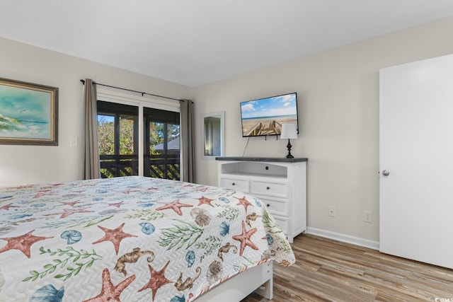 bedroom with access to outside and light hardwood / wood-style flooring