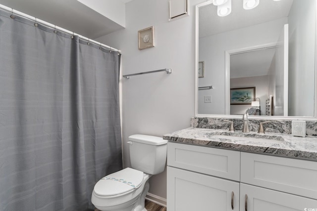 bathroom with vanity, hardwood / wood-style flooring, and toilet