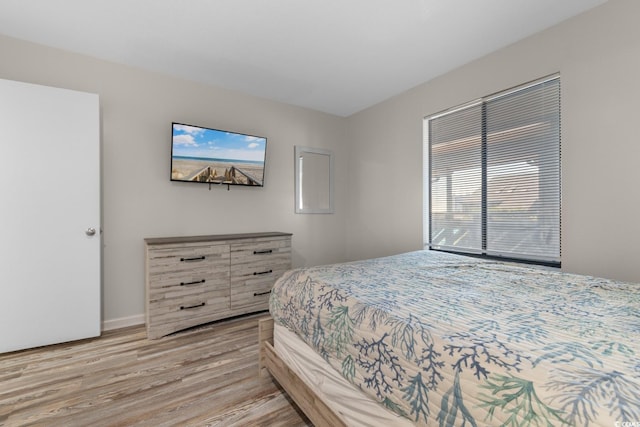 bedroom featuring multiple windows and light hardwood / wood-style flooring