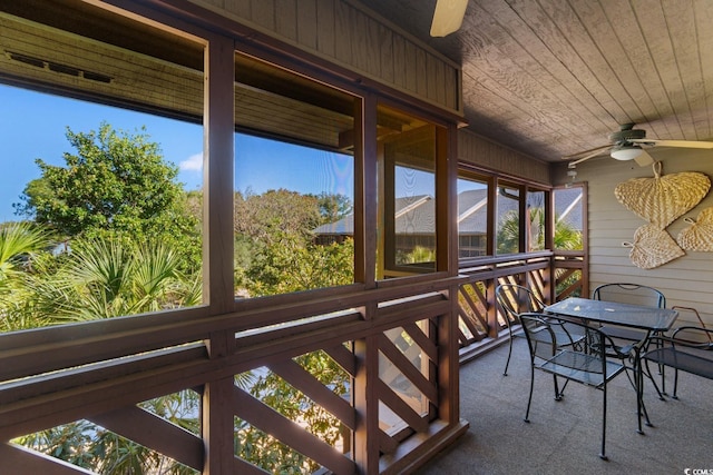 sunroom / solarium with ceiling fan and wood ceiling