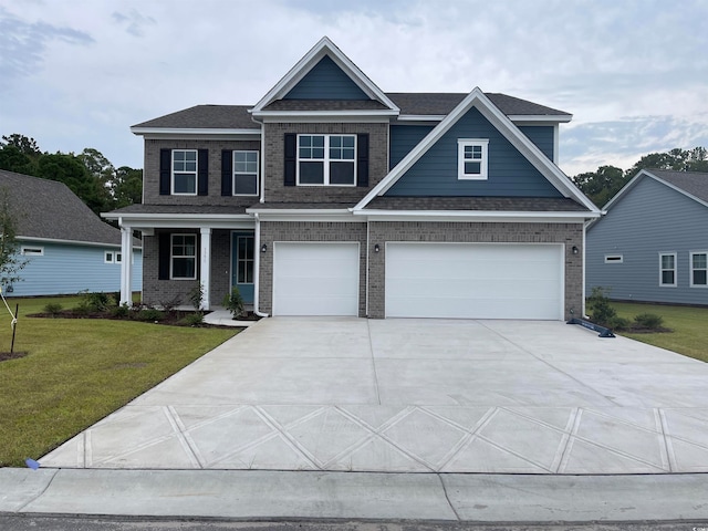 craftsman house with a garage and a front yard