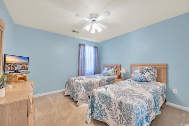 bedroom with light carpet and ceiling fan