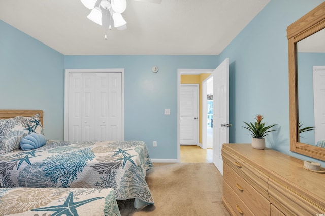 bedroom with light carpet, a closet, and ceiling fan