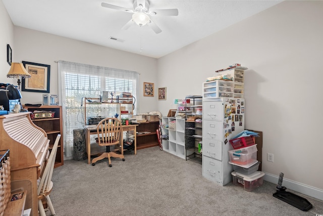carpeted home office with visible vents and ceiling fan