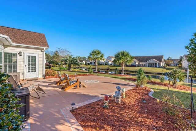 view of patio / terrace featuring a water view and a residential view