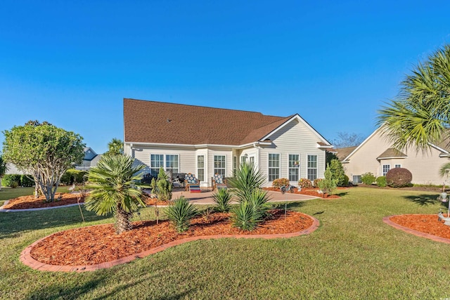 rear view of house with a patio area and a lawn