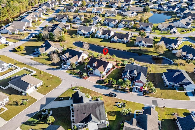 drone / aerial view featuring a water view and a residential view