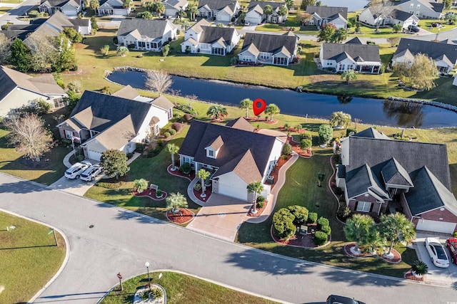 birds eye view of property featuring a water view and a residential view