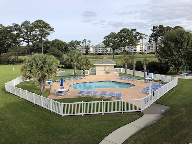 view of swimming pool with a lawn and a patio area