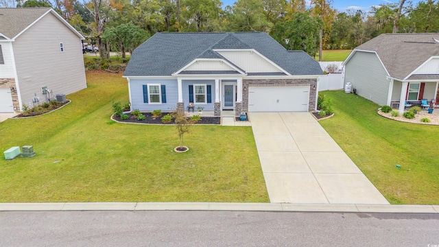craftsman-style house with an attached garage, a shingled roof, driveway, and a front lawn