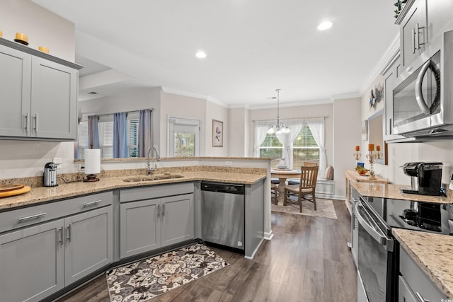 kitchen featuring gray cabinets, a peninsula, a sink, and stainless steel appliances