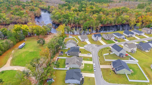 birds eye view of property with a water view, a residential view, and a wooded view