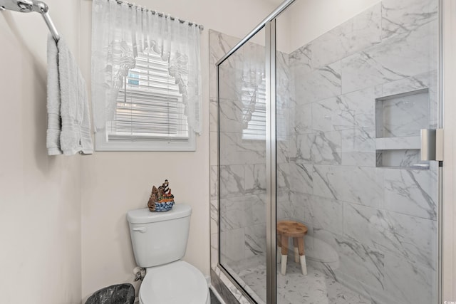 bathroom with an enclosed shower and toilet