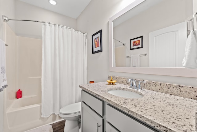 full bathroom with hardwood / wood-style floors, vanity, toilet, and shower / bath combo