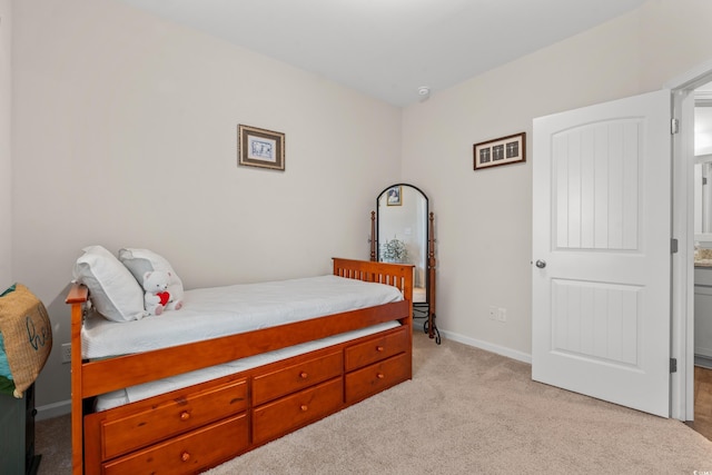 bedroom featuring baseboards and light carpet