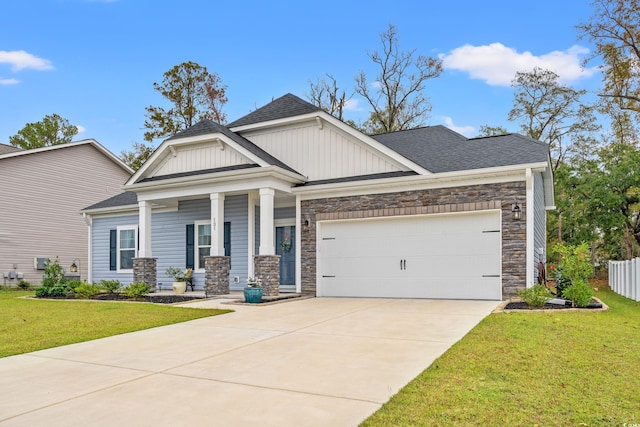 craftsman house with a front yard and a garage