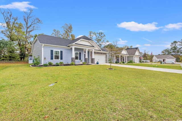 view of front of home with a front yard and a garage