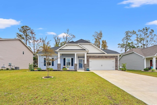 craftsman-style home featuring concrete driveway, stone siding, board and batten siding, a front lawn, and a garage
