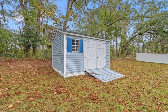 view of shed featuring fence
