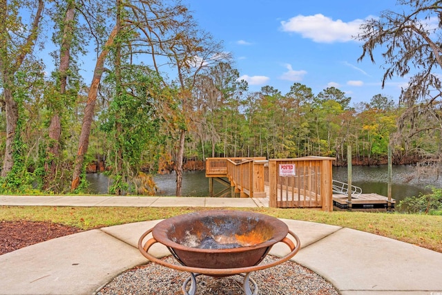 view of patio / terrace with a water view and a dock