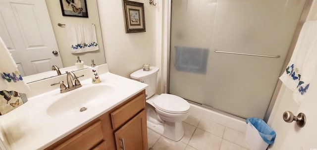 full bathroom featuring vanity, toilet, tile patterned flooring, and a stall shower