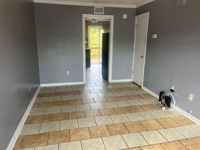 spare room featuring crown molding