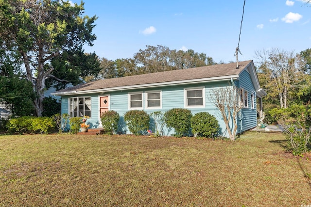 ranch-style home with a front lawn