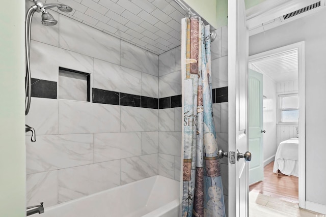 bathroom with wood-type flooring and shower / bathtub combination with curtain