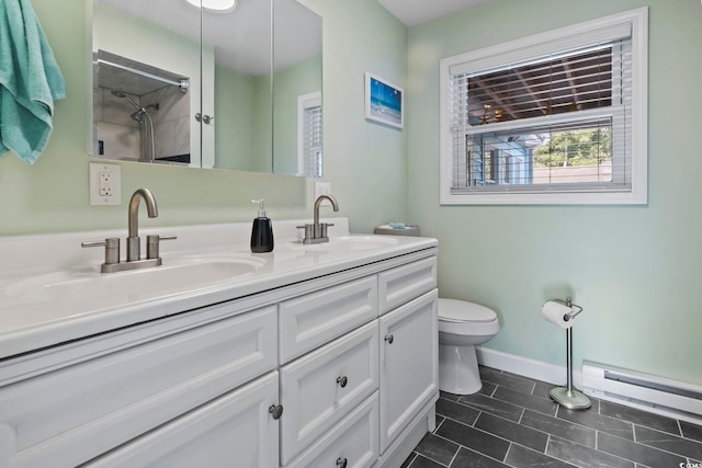 bathroom featuring toilet, vanity, and a baseboard heating unit