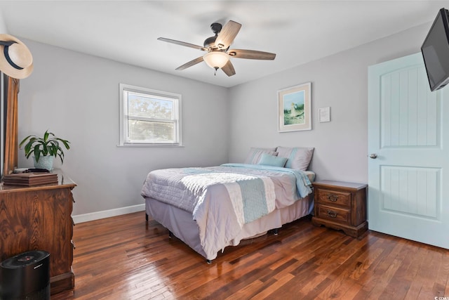 bedroom with ceiling fan and dark hardwood / wood-style flooring