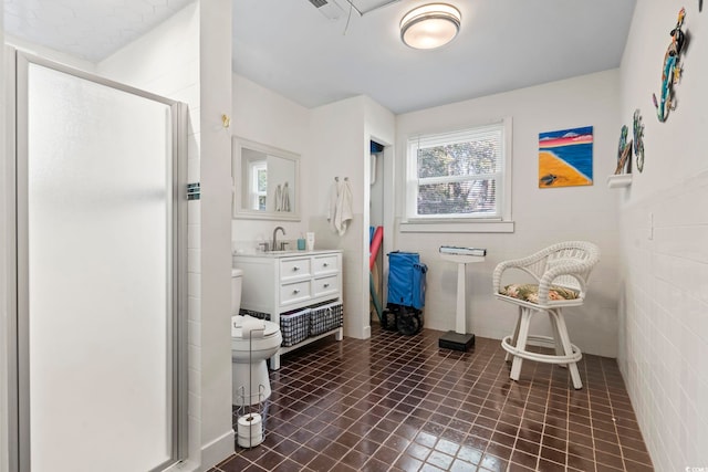 bathroom featuring tile patterned floors, toilet, and an enclosed shower