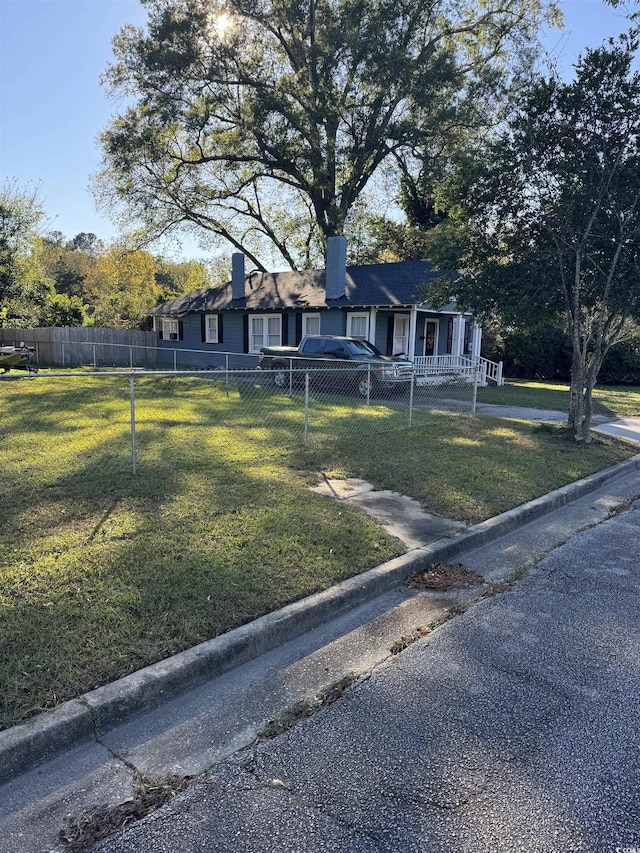 view of front of home featuring covered porch and a front yard