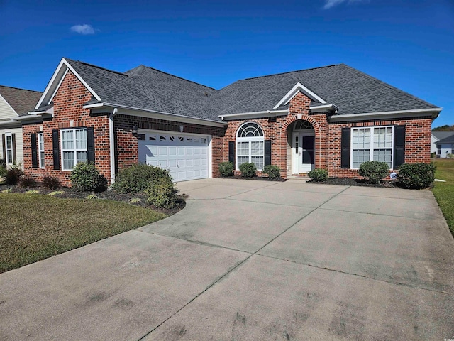 view of front of house featuring a garage and a front lawn