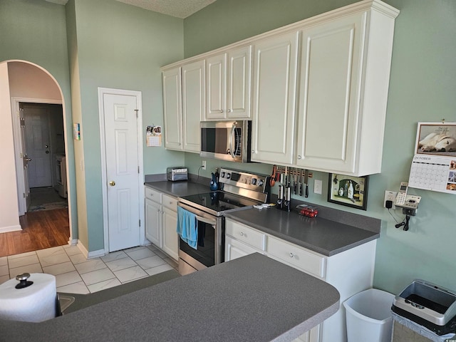 kitchen featuring white cabinets, light hardwood / wood-style floors, and appliances with stainless steel finishes