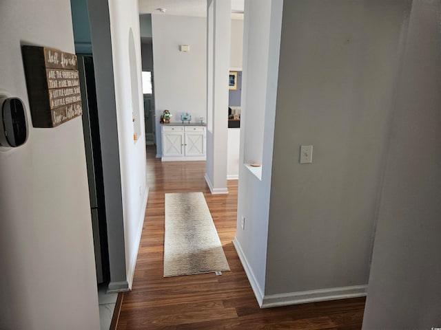 corridor with dark hardwood / wood-style floors