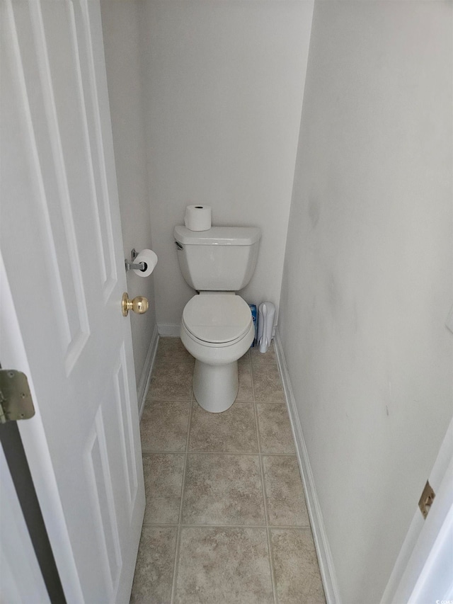 bathroom featuring tile patterned flooring and toilet