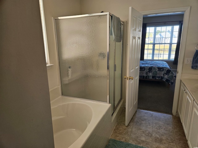 bathroom with tile patterned flooring, vanity, and separate shower and tub