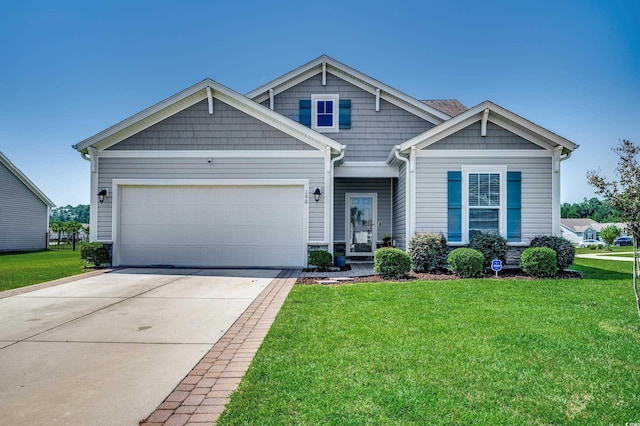 craftsman house with a garage and a front lawn