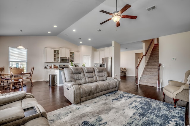 living room with dark hardwood / wood-style flooring, ceiling fan, and lofted ceiling