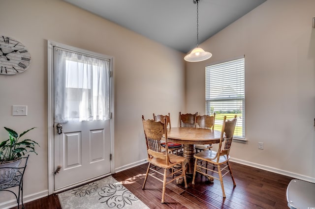 dining space featuring dark hardwood / wood-style floors and vaulted ceiling