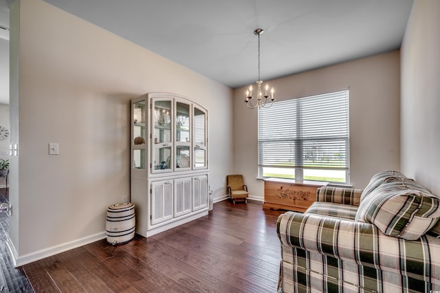 sitting room featuring a notable chandelier and dark hardwood / wood-style flooring